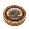 Gold oval box with purpurine center set with micromosaic floral design