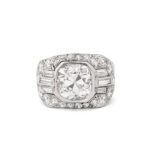 Cushion-cut diamond ring set in platinum, the mount set with brilliant-cuts and baguettes