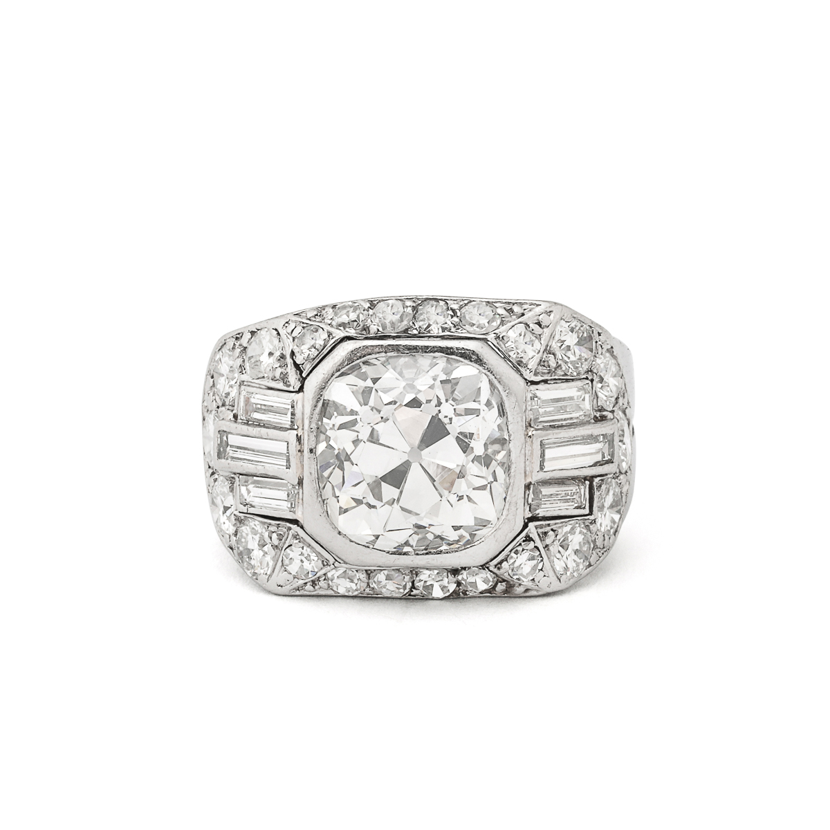 Cushion-cut diamond ring set in platinum, the mount set with brilliant-cuts and baguettes