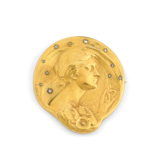 gold medallion brooch with relief of lady in profile, surrounded by diamond stars