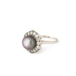 three quarter view of black button pearl and diamond ring