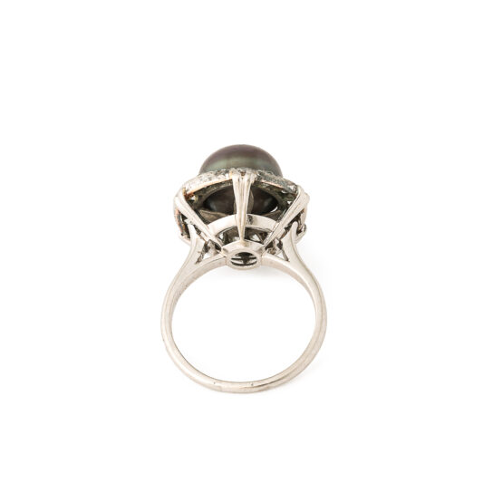 side view showing platinum mount of black button pearl and diamond ring