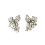 Cartier diamond earrings, each one designed as a cluster of two flowers with a leaf