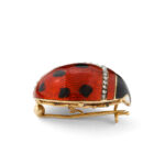 red and black enamel ladybug brooch set in gold with diamonds, side view